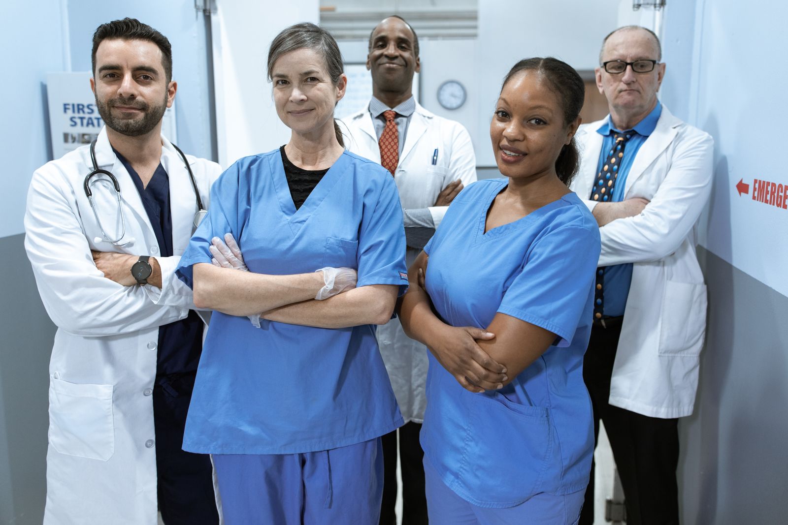 Healthcare professionals standing together in a clinic hallway